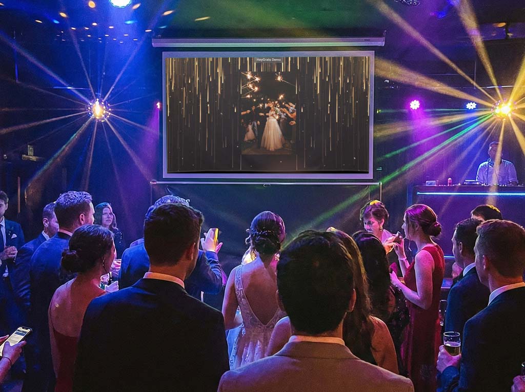 Live photo wall slideshow projected on a big screen at an event