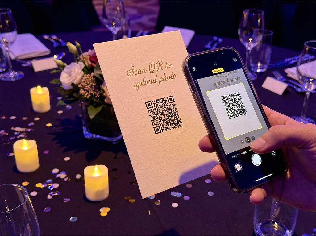Guest scanning an event QR code with their phone to upload photos